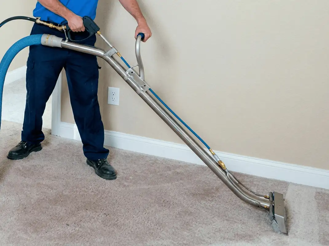 Professional operating a liquid removal machine on a carpeted floor in Fort Worth, TX